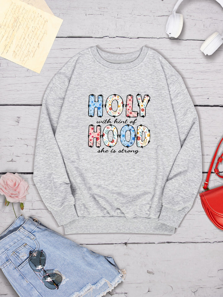 HOLY WITH HINT OF HOOD SHE IS STRONG Round Neck Sweatshirt | Trendsi