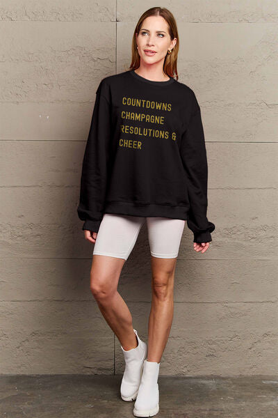 Simply Love Full Size COUNTDOWNS CHAMPAGNE RESOLUTIONS & CHEER Round Neck Sweatshirt | Trendsi